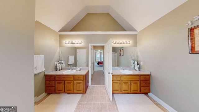 bathroom with vanity and high vaulted ceiling