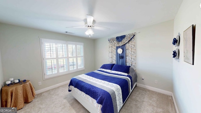 bedroom with light carpet and ceiling fan