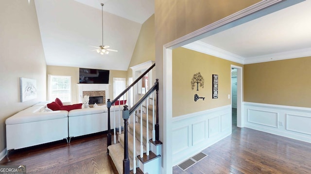 interior space featuring dark hardwood / wood-style flooring, crown molding, and lofted ceiling