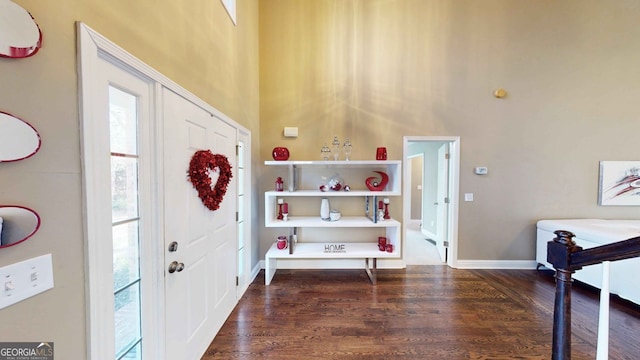 entrance foyer featuring dark wood-type flooring and a high ceiling