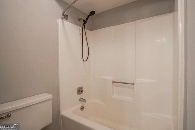 bathroom with bathing tub / shower combination and toilet