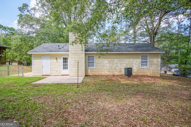 back of property featuring central AC, a patio, and a lawn