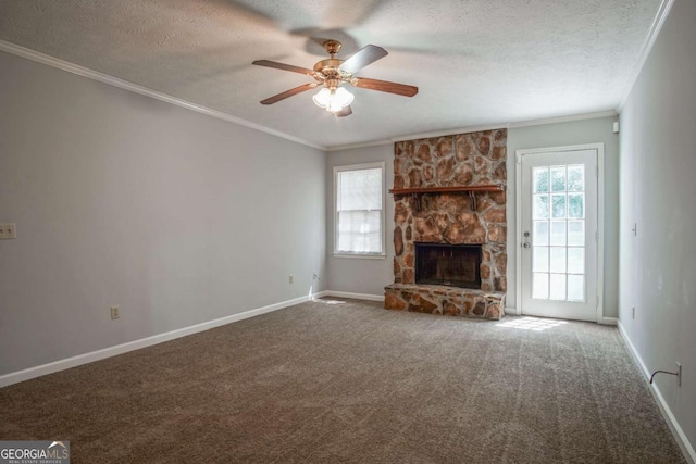 unfurnished living room featuring a fireplace, crown molding, carpet floors, and a textured ceiling