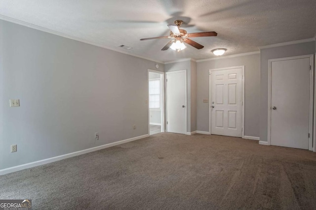 unfurnished room with crown molding, ceiling fan, carpet, and a textured ceiling