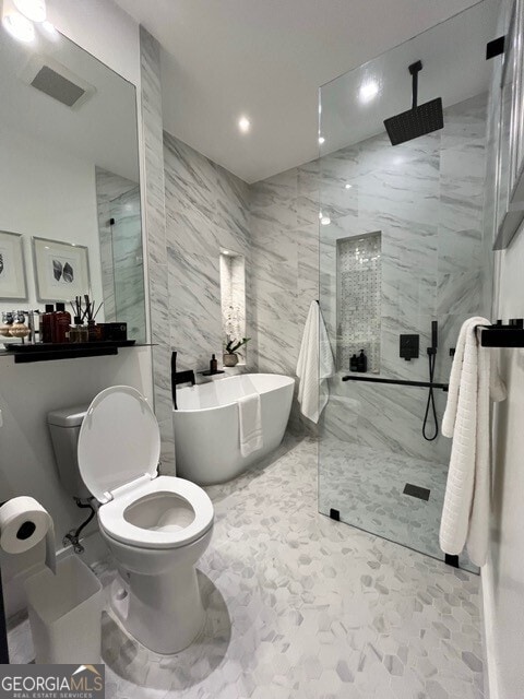 bathroom with toilet, plus walk in shower, and tile walls