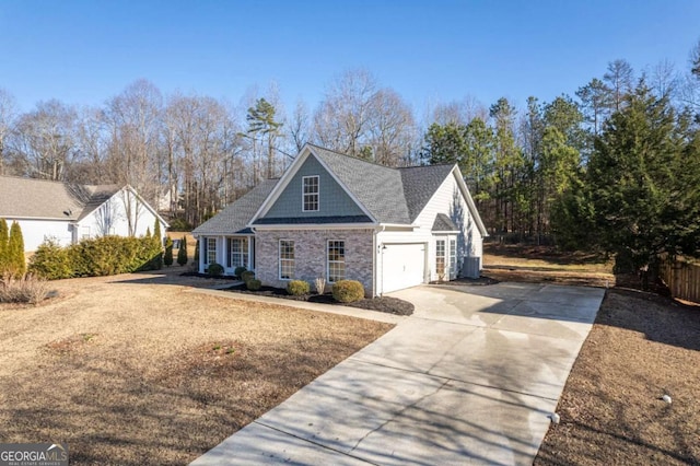 view of front of house featuring a garage and central AC