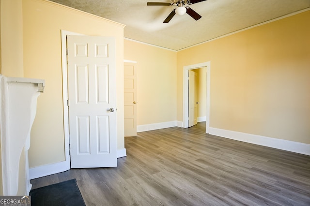 unfurnished bedroom featuring ceiling fan, ornamental molding, and hardwood / wood-style floors