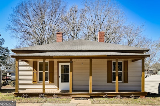 back of property with a porch