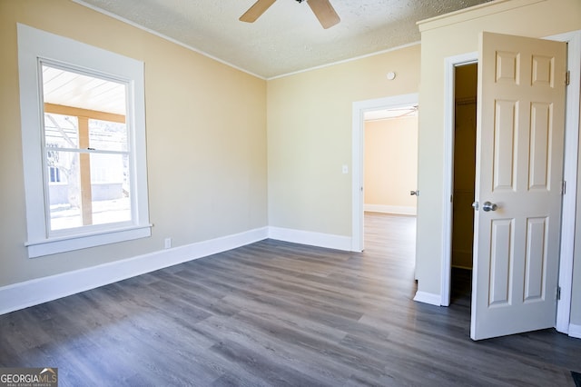 unfurnished room featuring ornamental molding, dark hardwood / wood-style floors, ceiling fan, and a textured ceiling