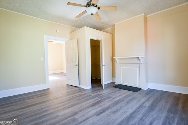 unfurnished living room featuring crown molding, hardwood / wood-style floors, ceiling fan, and a textured ceiling