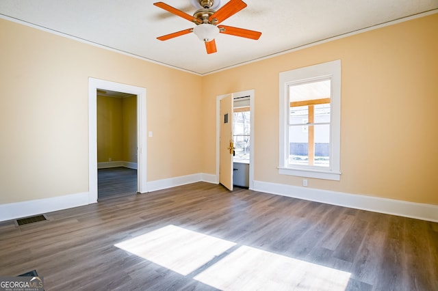 empty room featuring hardwood / wood-style floors, crown molding, and ceiling fan