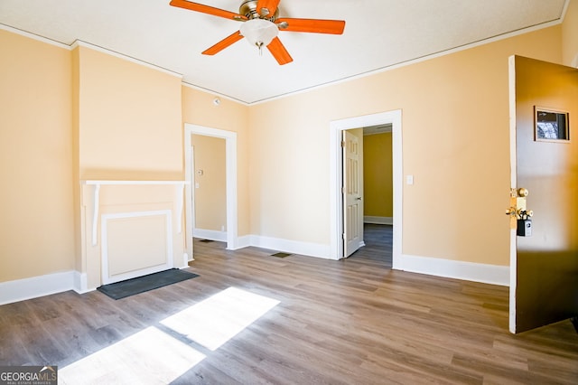 unfurnished living room with ornamental molding, hardwood / wood-style floors, and ceiling fan