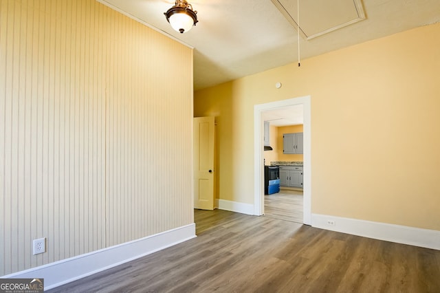 spare room with wood-type flooring