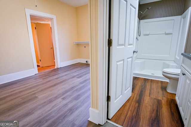 bathroom with vanity, hardwood / wood-style floors, toilet, and walk in shower