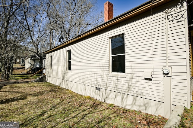 view of home's exterior with a lawn