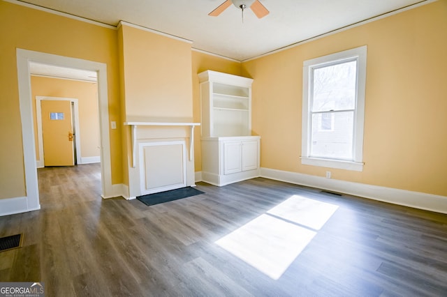 unfurnished living room featuring crown molding, ceiling fan, and dark hardwood / wood-style floors