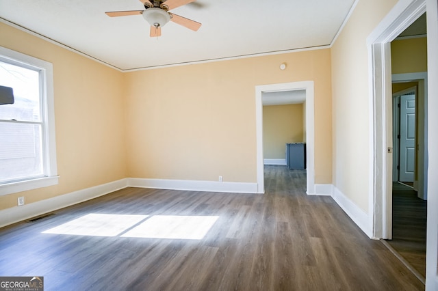 empty room featuring hardwood / wood-style floors, crown molding, and ceiling fan