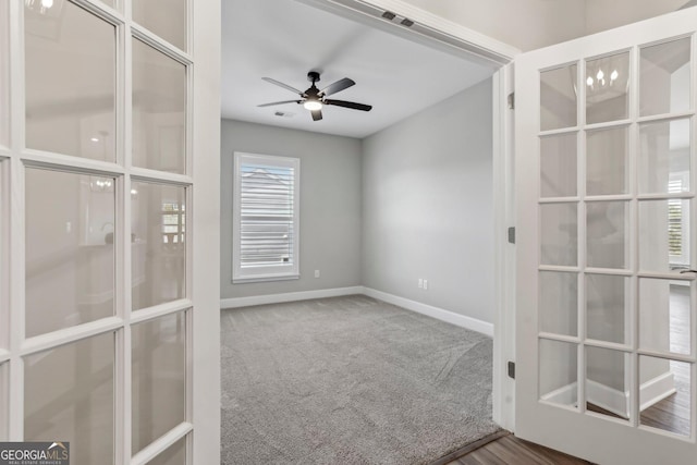 carpeted empty room with ceiling fan