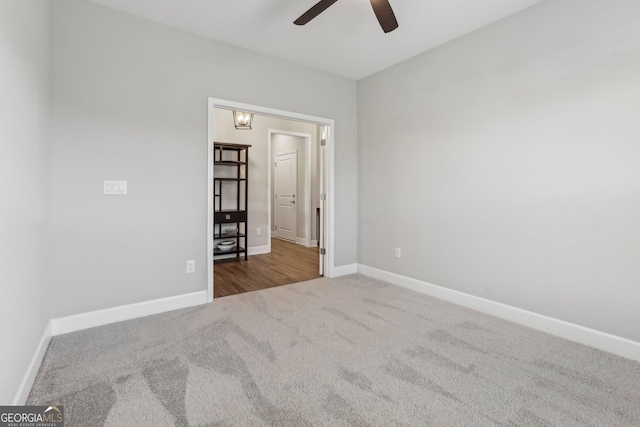 spare room with ceiling fan and carpet