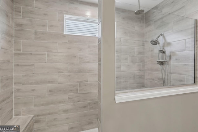 bathroom with tiled shower