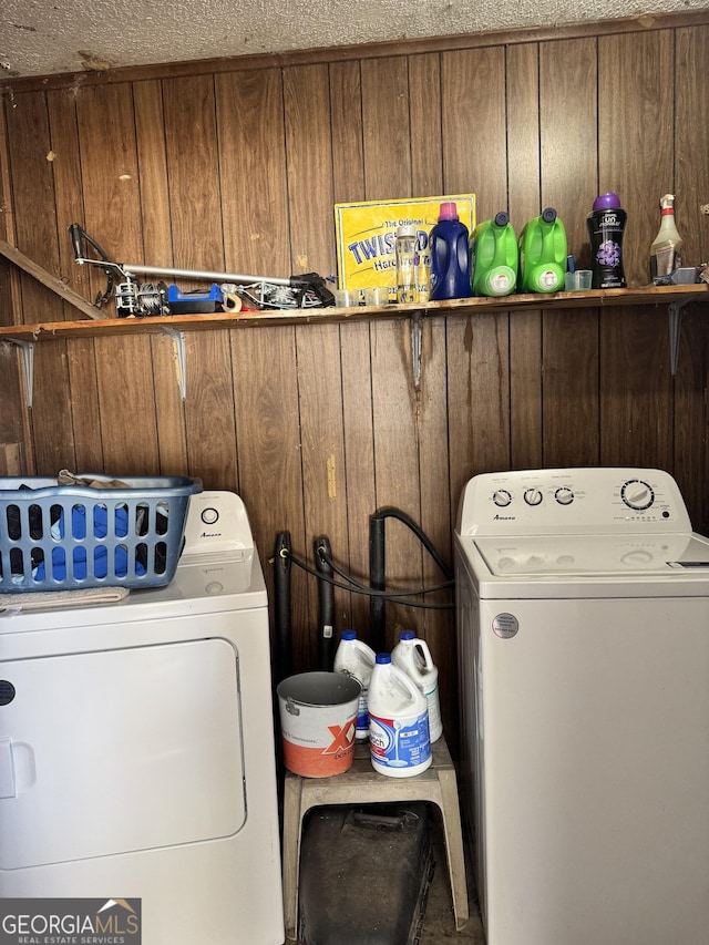 laundry area featuring wood walls