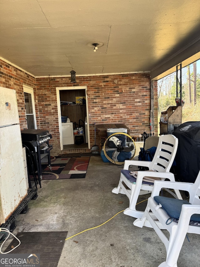 view of patio / terrace featuring a grill and washer / dryer