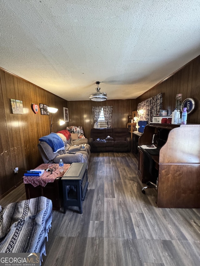 living room with dark wood-type flooring and a textured ceiling