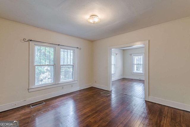 spare room with dark wood-type flooring