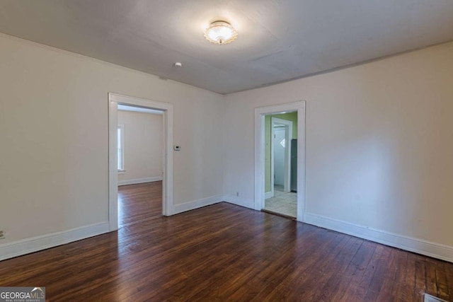 unfurnished room featuring dark wood-type flooring