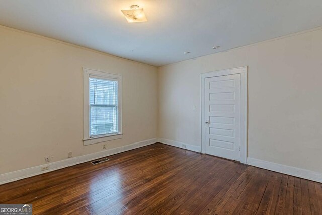 spare room with dark hardwood / wood-style floors