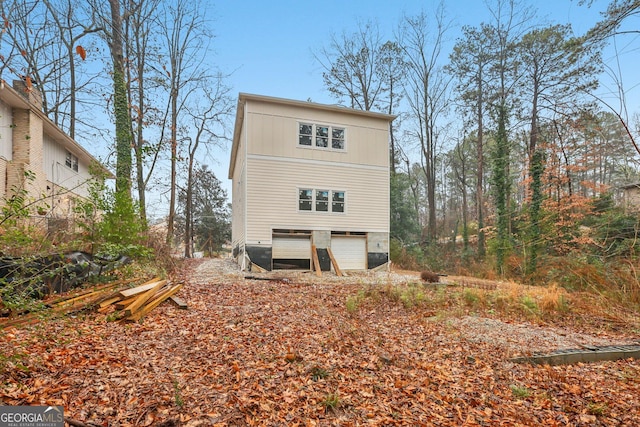 rear view of house with a garage