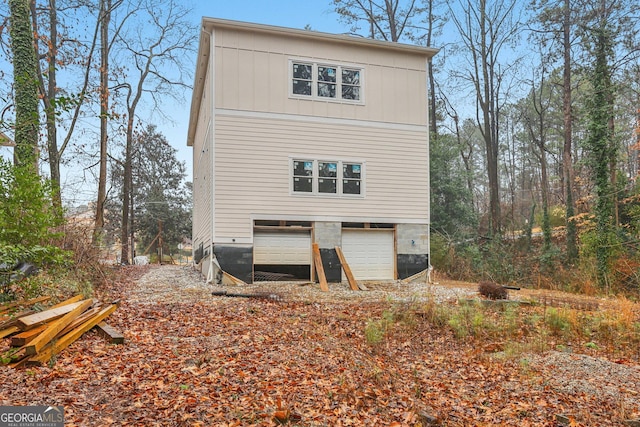 rear view of property with a garage