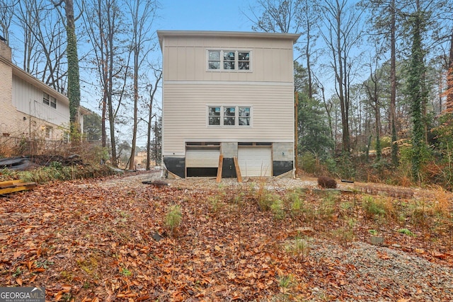 back of property with a garage