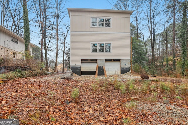 back of property featuring a garage