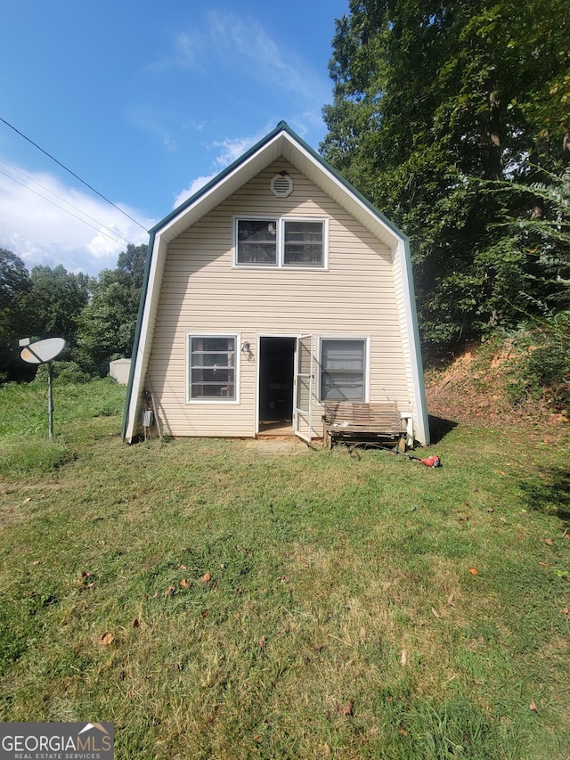 rear view of house with a lawn