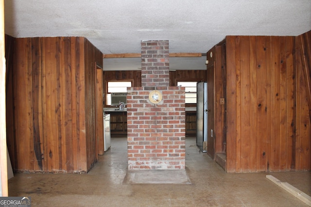 interior space featuring wooden walls and a textured ceiling