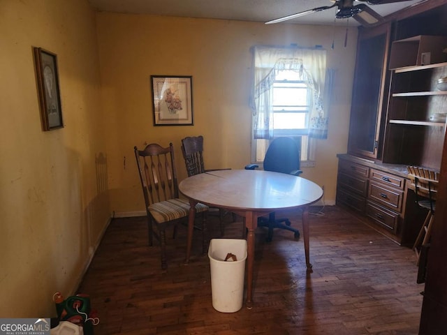 dining space with ceiling fan and dark hardwood / wood-style flooring