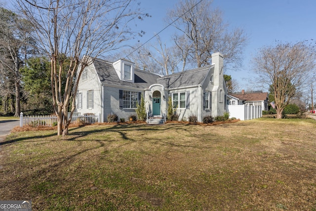 cape cod home with a front lawn