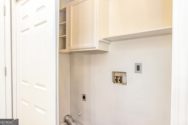 clothes washing area featuring cabinets, washer hookup, and hookup for an electric dryer