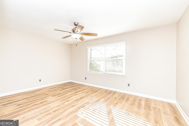 empty room with ceiling fan and light hardwood / wood-style floors