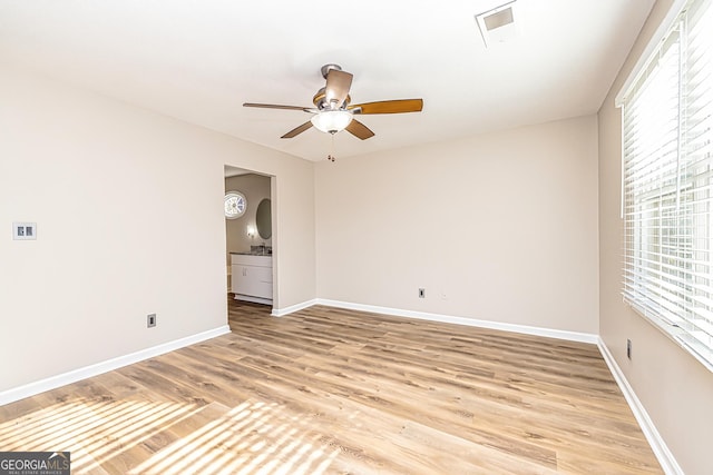 empty room with light hardwood / wood-style floors and ceiling fan