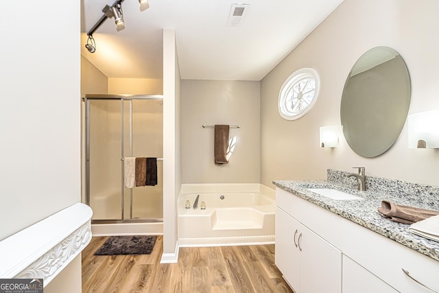 bathroom featuring vanity, hardwood / wood-style floors, and independent shower and bath