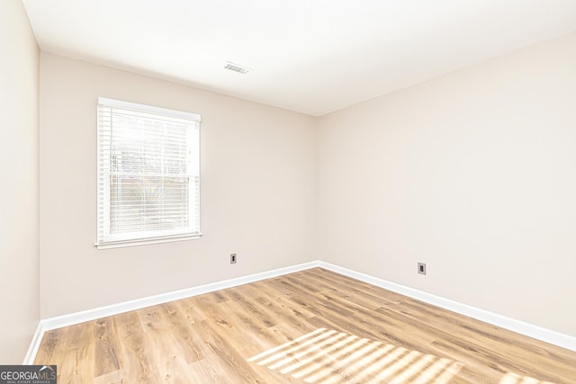 unfurnished room featuring light hardwood / wood-style floors