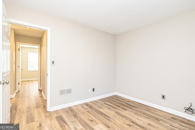 spare room with light wood-type flooring