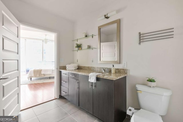 bathroom with vanity, tile patterned floors, and toilet