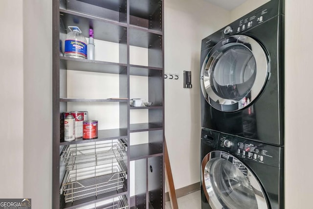 laundry room featuring stacked washer / drying machine