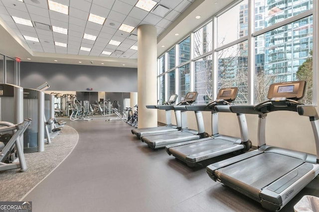 gym with a high ceiling and a drop ceiling