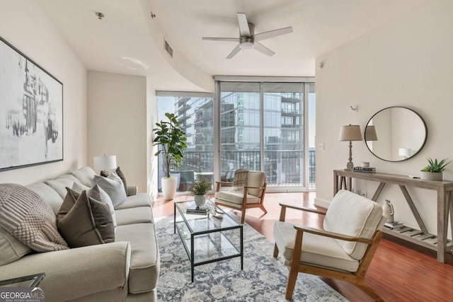 living room featuring hardwood / wood-style floors, floor to ceiling windows, and ceiling fan