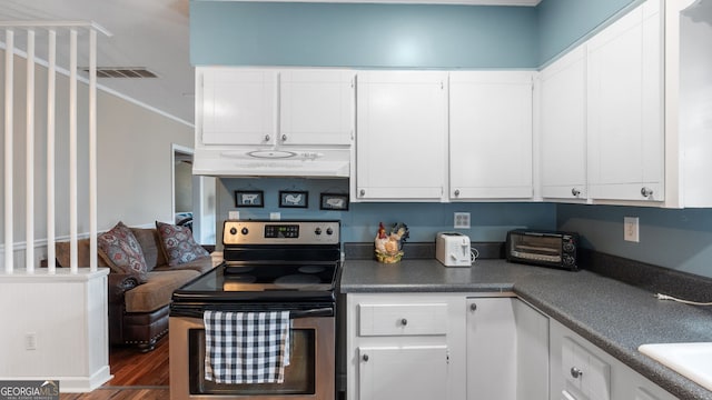 kitchen featuring white cabinetry, stainless steel electric stove, dark wood-type flooring, and crown molding