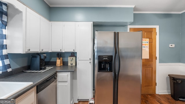 kitchen with ornamental molding, appliances with stainless steel finishes, dark hardwood / wood-style floors, and white cabinets